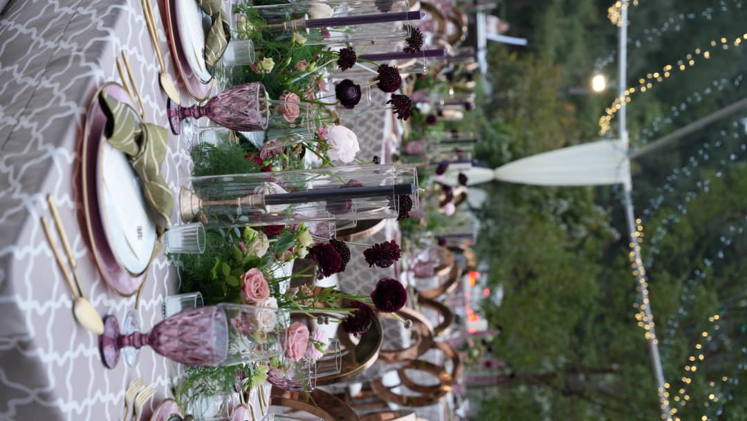 Romantic wedding reception table with luxury floral arrangements